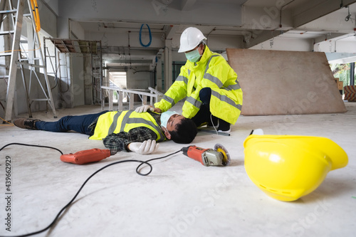 An accident of a man worker at the construction site. The assist those injured in the primary. Selection focus on an Injured person.