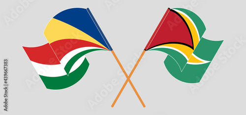 Crossed and waving flags of Seychelles and Guyana