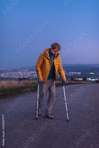 Man with paraparesis using crutches  photo