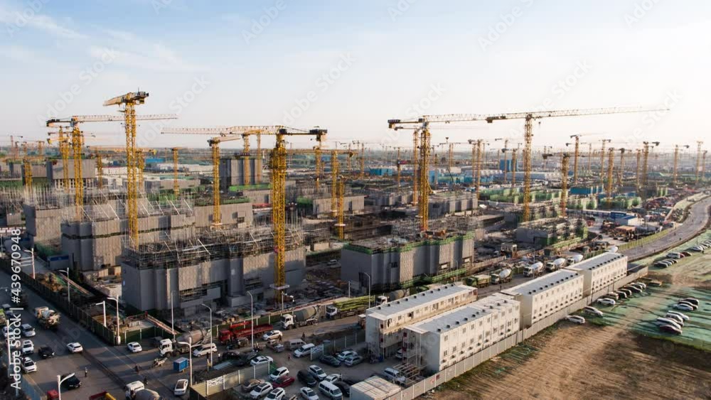Aerial Flight Over a New Constructions Development Site with High Tower Cranes Building Real Estate. Heavy Machinery and Construction Workers are Employed. Xiongan new area of Beijing china. Aerial Flight Over a New Constructions Development Site with High Tower Cranes Building Real Estate. Heavy Machinery and Construction Workers are Employed. Xiongan new area of Beijing china.