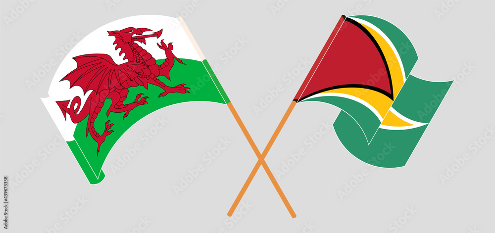 Crossed and waving flags of Wales and Guyana