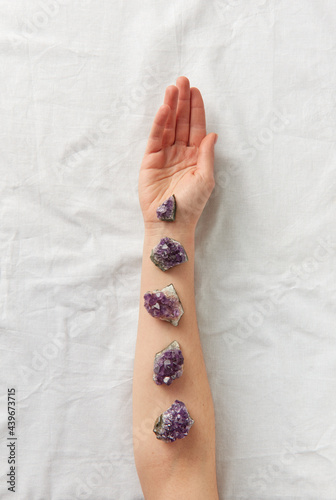 Female hand with amethyst crystals photo