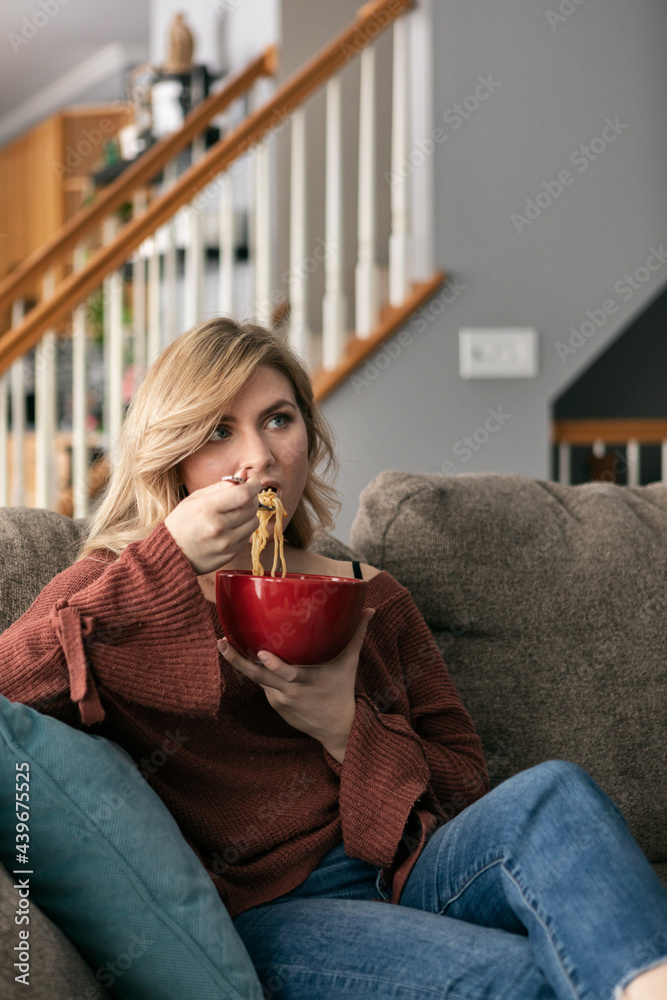 Home: Woman Eating Noodle Bowl While Watching TV Home: Woman Eating Noodle Bowl While Watching TV
