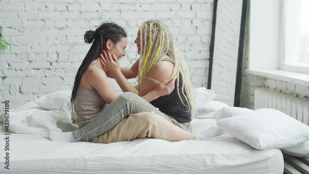 LGBT lesbian girls embracing and sharing secrets in bed LGBT lesbian girls embracing and sharing secrets in bed