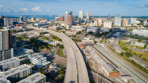 Cinematic drone shot over the Selmon Expressway leading through downtown Tampa. photo