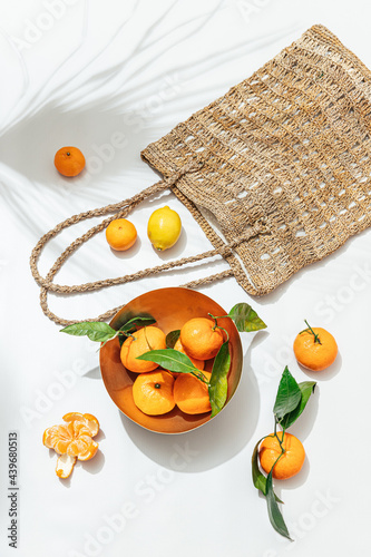 Still life of handwoven tote bag with citrus fruit photo