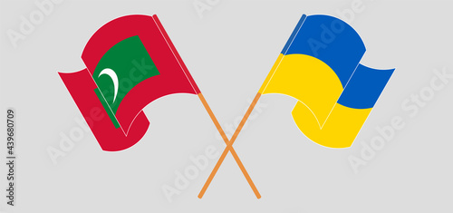 Crossed and waving flags of Maldives and Ukraine
