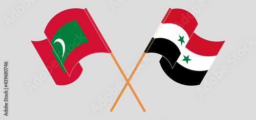 Crossed and waving flags of Maldives and Syria