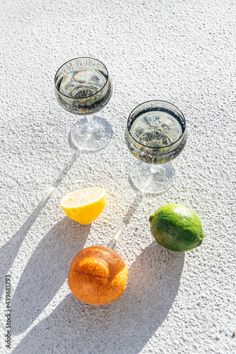 Still life of citrus and glassware on concrete background