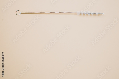 Top view of straw cleaning brushisolated on light brown background photo