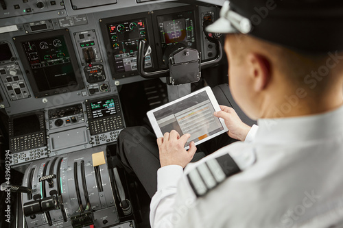 Pilot use digital tablet in passenger airplane jet