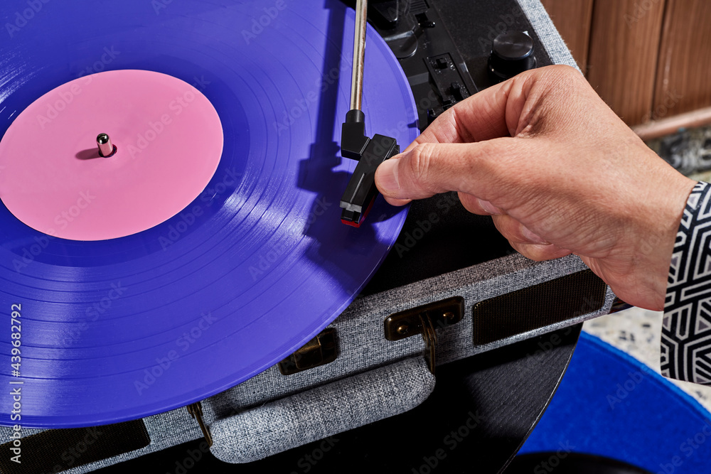 man playing a disc in a turntable