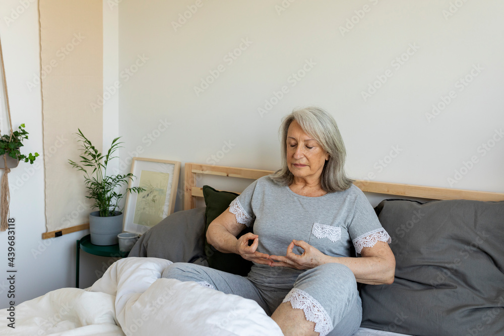 mature woman meditating during morning time at home mature woman meditating during morning time at home
