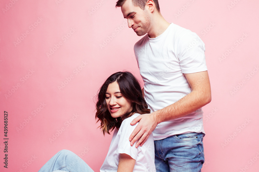 young cheerful caucasian couple together having fun on pink background, guy ang girl modern relationship, lifestyle people concept young cheerful caucasian couple together having fun on pink background, guy ang girl modern relationship, lifestyle people concept
