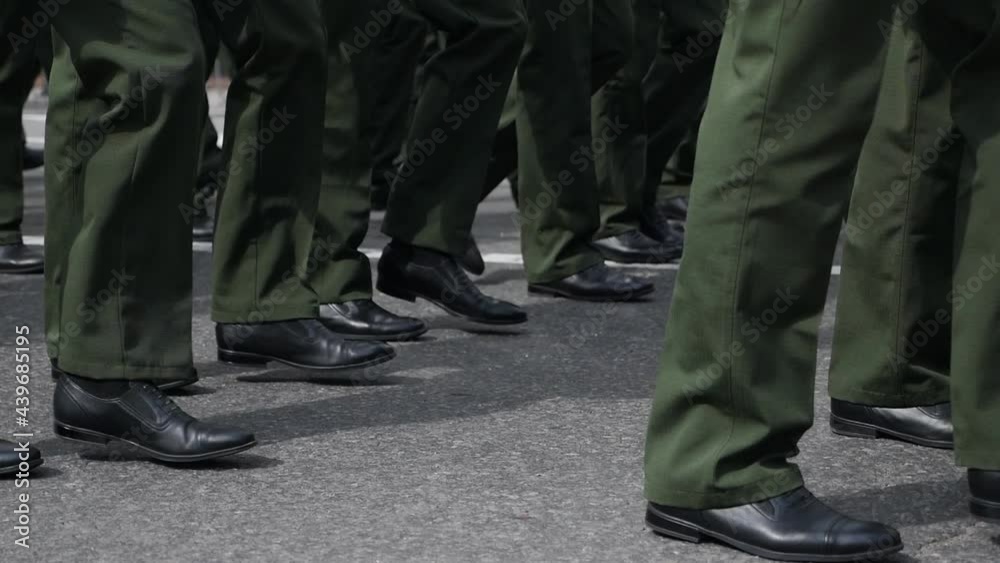 Close-up of the legs of military personnel, in green uniform, marching in the parade, in slow motion. Military march Close-up of the legs of military personnel, in green uniform, marching in the parade, in slow motion. Military march