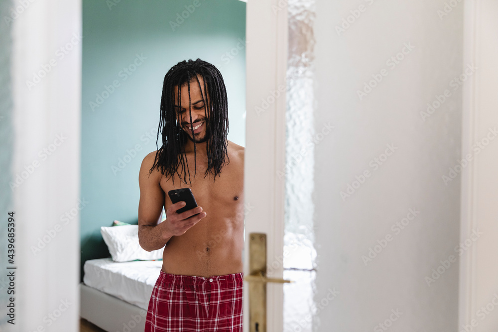 Man using his cellphone at home Man using his cellphone at home