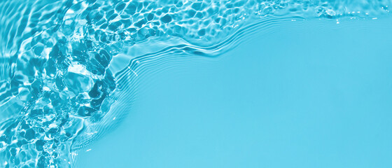 Transparent blue clear water surface texture with ripples, splashes and bubbles. Abstract summer banner background Water waves in sunlight with copy space Cosmetic moisturizer micellar toner emulsion