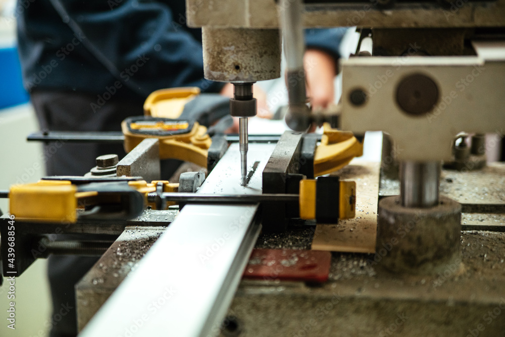 Master using drilling machine in workshop Master using drilling machine in workshop