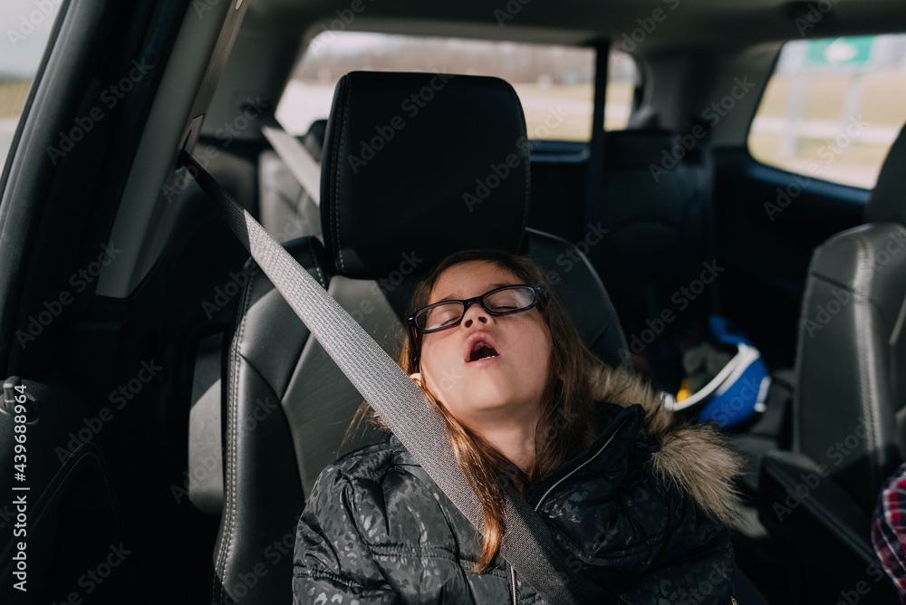 Girl sleeping with mouth open in the car. Stock Photo Adobe Stock