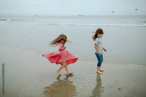 Girl watches sister dress billow out