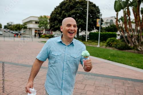 Smiling bald man with ice cream cone 