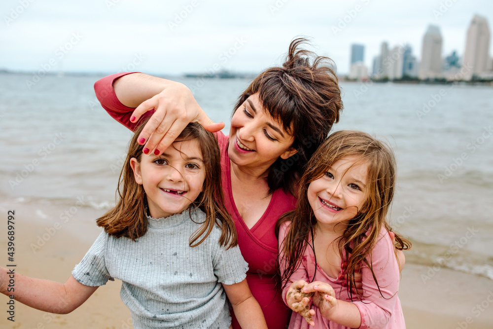 Happy mom with smiling girls at the beach Happy mom with smiling girls at the beach