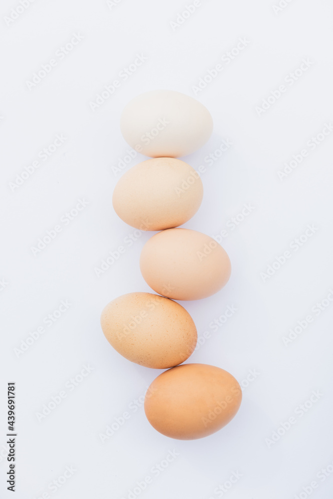 Different shades of eggs in the line on the white background Different shades of eggs in the line on the white background