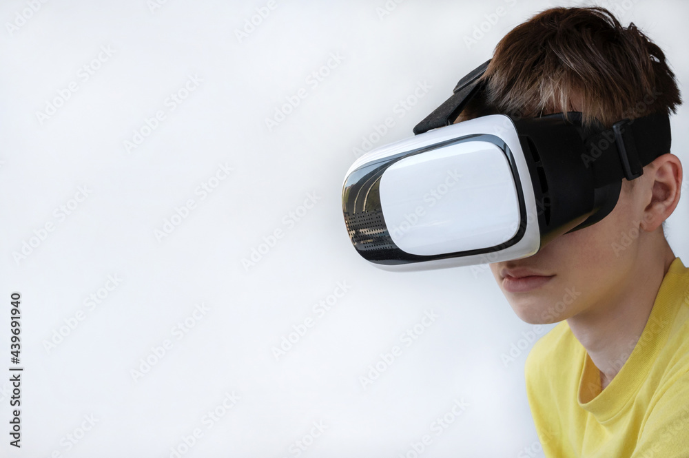 Portrait of a young man wearing virtual reality glasses. The concept of technology, science, innovation, and cyberspace. Copy space Portrait of a young man wearing virtual reality glasses. The concept of technology, science, innovation, and cyberspace. Copy space