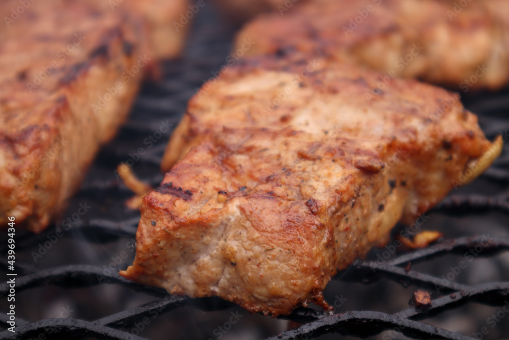 Pork steak close - up on the grill