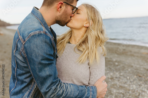 Husband and wife kissing on the beach photo