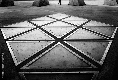 Legs of a runner on a pentagon glass structure. photo