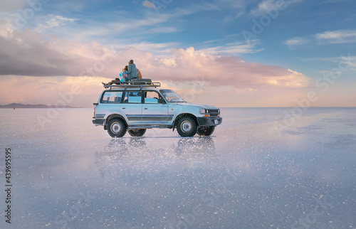 off-road vehicle stands on the salt flat of Uyunu at sunset. Road trip to Bolivia, South America