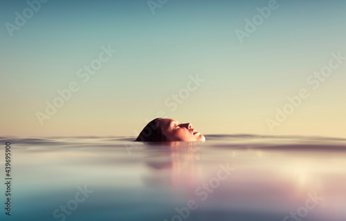 Side view from a floating girl in the sea photo
