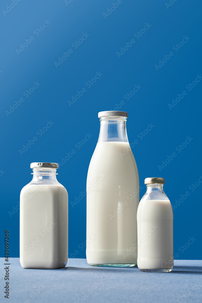 Milk bottles on blue background Milk bottles on blue background
