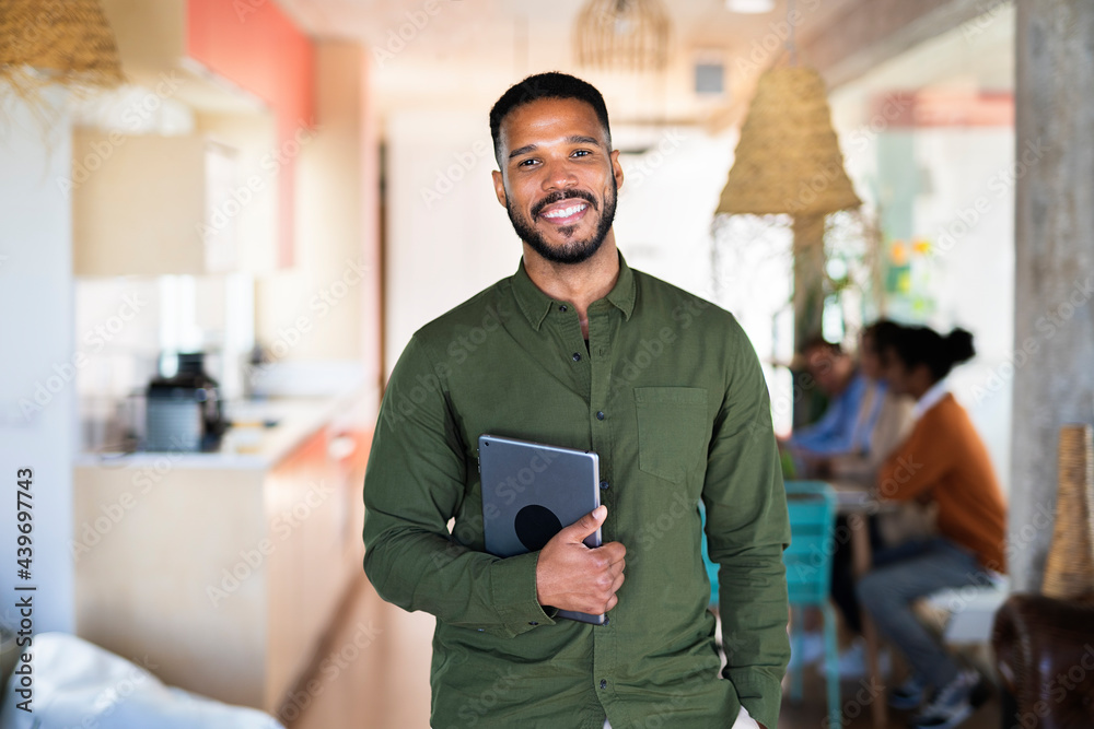 © Santi Nuñez/Stocksy - African American Business Man Using Tablet