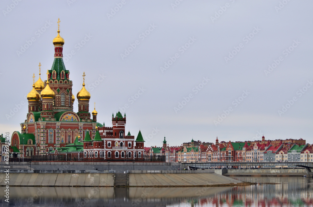 Cathedral of the Epiphany against the backdrop of the Embankment of Bruges and the theatre bridge. Russia Yoshkar Ola 01.05.2021. High quality photo