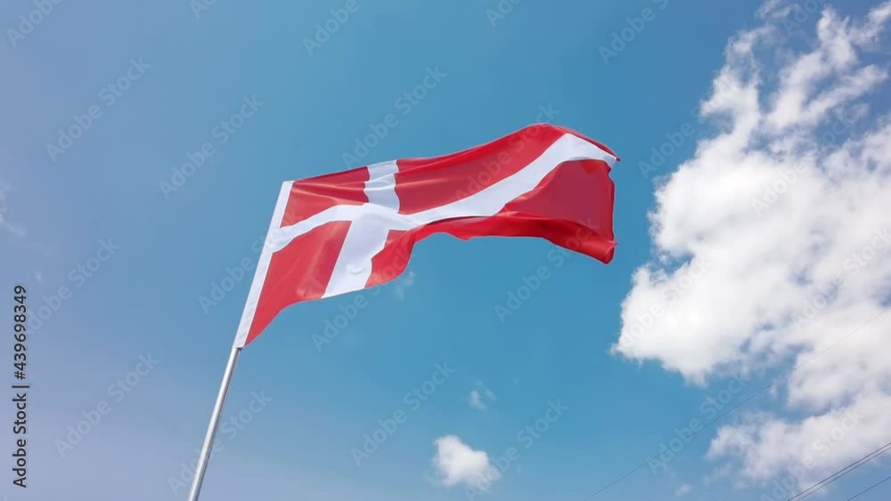 Denmark. National country flag on blue sky background. Flying fabric symbol. Tourism or travel summer day. international patriotic emblem. Nobody. Horizontal video Denmark. National country flag on blue sky background. Flying fabric symbol. Tourism or travel summer day. international patriotic emblem. Nobody. Horizontal video