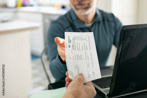 Taxes: Woman Hands 1099 Income Form To Husband