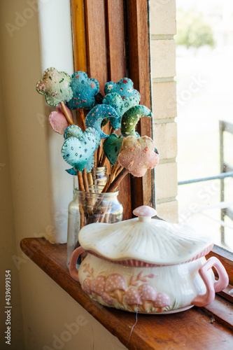 Hand-made felt wand sitting on a windowsill.