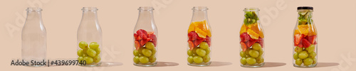 filling glass bottles with fruit photo