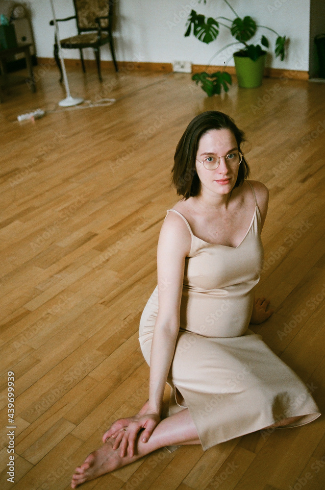 Pregnant woman sitting on a floor Pregnant woman sitting on a floor
