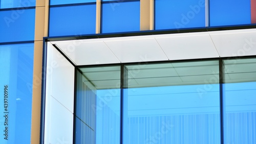 Glass facade of the buildings with a blue sky. Modern building in the business city center. Background of modern glass buildings. 