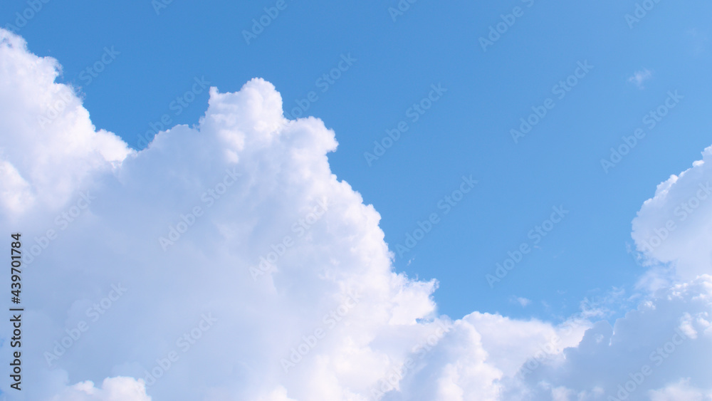 Fluffy white clouds on a blue sky