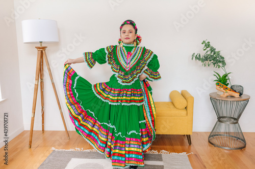 Portrait of a Mexican-American tween wearing a traditional Mexican dress