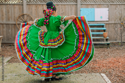 Portrait of a Mexican-American tween wearing a traditional Mexican dress photo