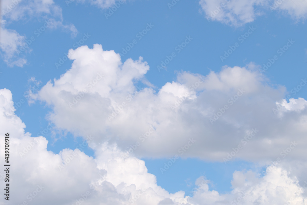 Fluffy white clouds on a blue sky