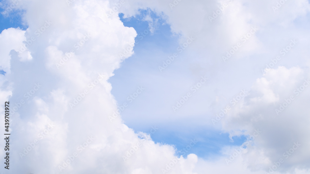 Fluffy white clouds on a blue sky