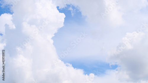 Fluffy white clouds on a blue sky © Disorder_Vortex
