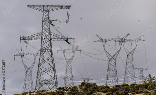 Green energy sources transmission tower on the mountain photo