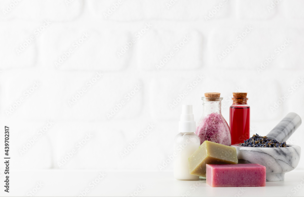 Cosmetics bottles and natural handmade soap on white background Cosmetics bottles and natural handmade soap on white background